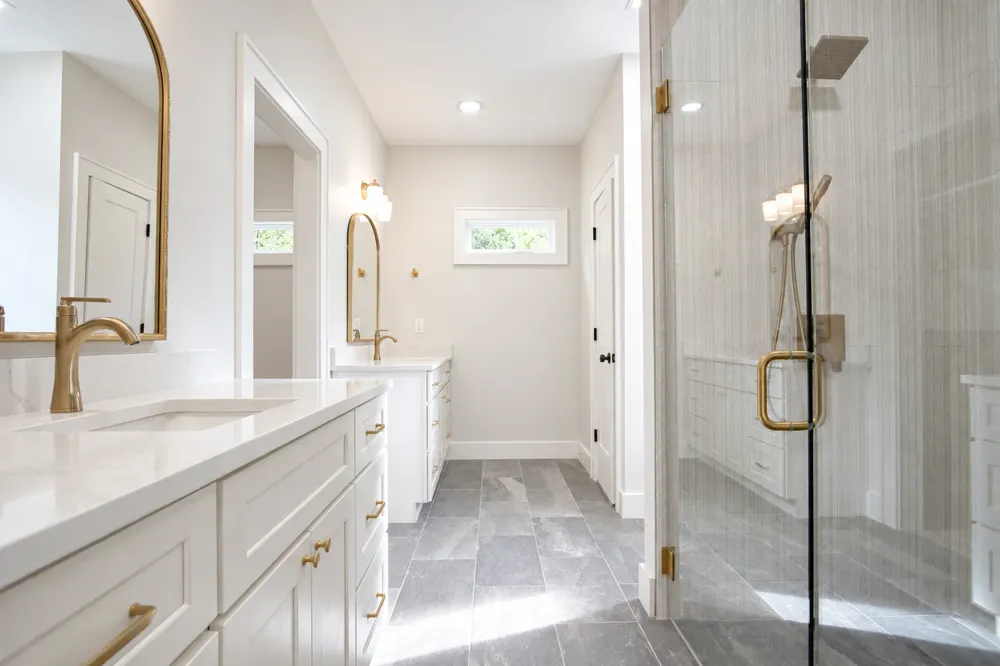 Saloli — Brass-accented bathroom corridor